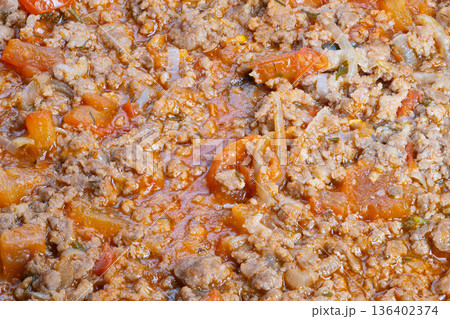 Overhead close up minced pork ragu bubbling, shredded cheese flecks and herb specks, meal prep suggestion for family dinner, highprotein savory base, quick weeknight comfort Overhead close up minced pork ragu bubbling, shredded cheese flecks and herb specks, meal prep suggestion for family dinner, highprotein savory base, quick weeknight comfort 136402374