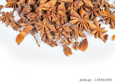 Festive star anise garnish for holiday table styling, scattered pods and crumbs on white surface create warm seasonal mood for mulled drinks, baking, and packaging concepts Festive star anise garnish for holiday table styling, scattered pods and crumbs on white surface create warm seasonal mood for mulled drinks, baking, and packaging concepts 136402405