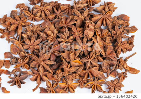 Closeup of aromatic spice pods. Detailed view of star anise on neutral background. Highresolution image capturing intricate structure of star anise pods with warm ambiance 136402420