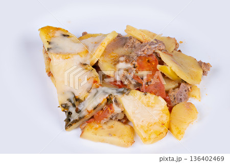 Potato bake details. Cheesy meat potato casserole closeup. Melted cheese layered potato with herbs and meat. Closeup view of cheesy baked potato with minced meat and herbs 136402469