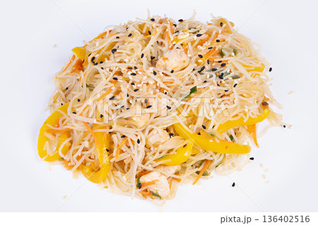 Vibrant rice vermicelli with yellow pepper and sesame, styled for social media foodshot with bright background and high contrast, shareable content for influencer posts 136402516