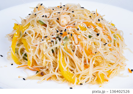 Crunchy rice nest. Delicious crispy noodle arrangement. Savory rice vermicelli with herbs. Freshly prepared crispy rice noodles with peppers and sesame seeds 136402526