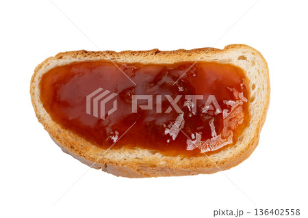 Comforting jam moment. Delicious homemade jam served on toasted bread with rustic charm. Cozy kitchen scene featuring sticky fruit jam spread on freshly toasted bread for comfort 136402558