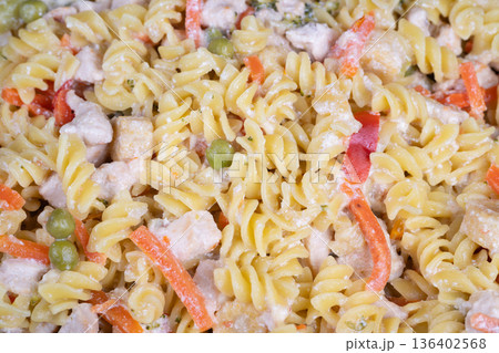 Creamy fusilli salad on display, stacked in clear containers at deli counter, garnished with parsley and light mayonnaise dressing, ready for takeaway during busy lunchtime Creamy fusilli salad on display, stacked in clear containers at deli counter, garnished with parsley and light mayonnaise dressing, ready for takeaway during busy lunchtime 136402568