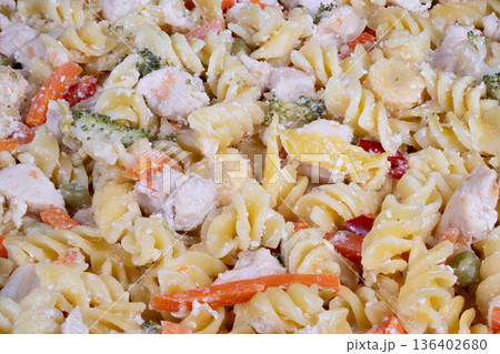 Light and cool pasta combining vegetables with cold cooked chicken. Straightforward dish featuring chilled chicken combined with fresh vegetables tossed with pasta 136402680