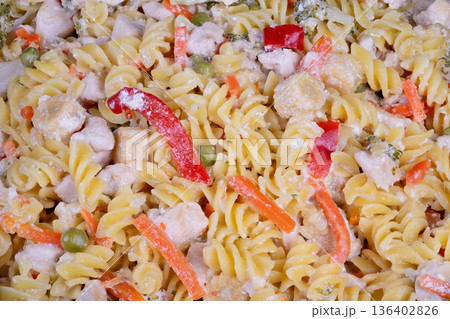 Rich veggie noodles. Elegant dish with vegetables and cheese. Closeup of smooth pasta topped with roasted peppers. Creamy vegetable pasta dish garnished with grilled red peppers Rich veggie noodles. Elegant dish with vegetables and cheese. Closeup of smooth pasta topped with roasted peppers. Creamy vegetable pasta dish garnished with grilled red peppers 136402826