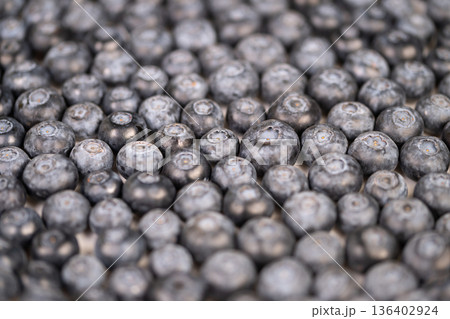 Earthtoned blueberries vividly illustrate environmentally conscious farming techniques. Rustic blueberries serve as visual symbols of sustainable practices in natural agriculture 136402924