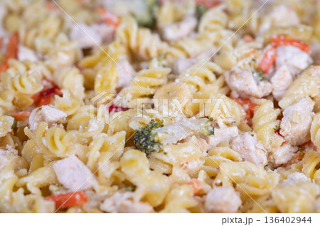 Exquisite fusilli pasta with microgreens and cheese garnish. Sophisticated presentation of gourmet fusilli pasta with microgreens and grated cheese for catering showcase 136402944