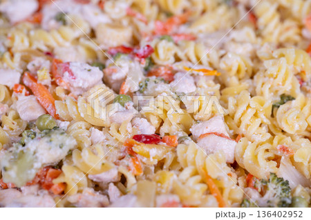 Nutritious meal with vegetables. Delicious fiberrich pasta with colorful peppers. Wholesome vegetable pasta combining peas and sweet peppers for health enthusiasts 136402952