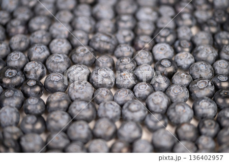Closeup cluster ripe blueberries showcasing delicate bloom and matte skin, shallow depth of field, cool bluegray palette evokes calm freshness for product and editorial use Closeup cluster ripe blueberries showcasing delicate bloom and matte skin, shallow depth of field, cool bluegray palette evokes calm freshness for product and editorial use 136402957