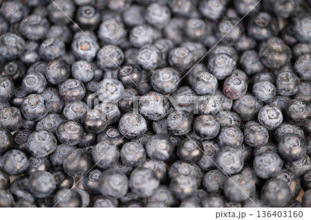 Berry preparation visuals. Vivid closeup of blueberries prepared for baking and blending. Detailed image of blueberries ready for culinary creations and recipe development Berry preparation visuals. Vivid closeup of blueberries prepared for baking and blending. Detailed image of blueberries ready for culinary creations and recipe development 136403160