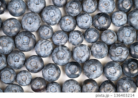 Fresh blueberries for smoothie bowl, vibrant blue tones convey antioxidant power, ideal for health, diet and wellness campaigns showcasing vitamin rich superfood 136403214