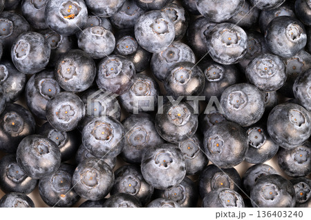 Closeup blueberries smoothie bowl recipe prep, frozen bloom shimmer, antioxidantrich appeal, vibrant indigo color, breakfast inspiration, spoon and granola pairing suggested 136403240
