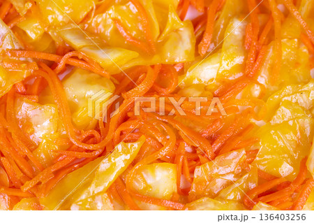 Vivid fermented vegetables. Detailed image of seasoned fermented vegetables with spicy oil. Magnified view of glistening pickled vegetables layered with fiery chili oil 136403256