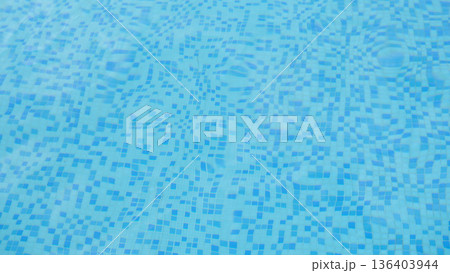 Calm water ripples dance under bright sunlight in a refreshing pool on a warm summer afternoon 136403944