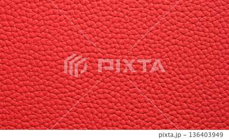 Vibrant texture of red leather, showcasing rich color and intricate pattern under bright light 136403949