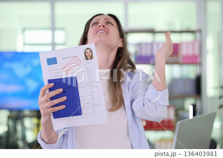 Frustration fills the air as a young woman learns about her visa rejection in a bright, modern office space Frustration fills the air as a young woman learns about her visa rejection in a bright, modern office space 136403981