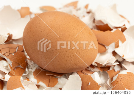 Close-up of a boiled unpeeled egg on an eggshell. Close-up of a boiled unpeeled egg on an eggshell. 136404056