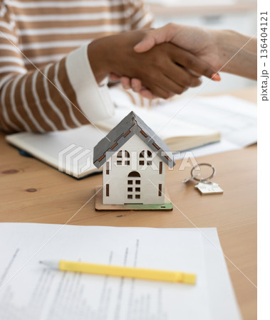 handshake between two people, conclusion of contract for sale of real estate. 136404121