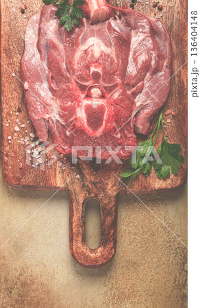raw steak, veal neck on the bone, fresh meat, on a cutting board, with spices, top view, without people, raw steak, veal neck on the bone, fresh meat, on a cutting board, with spices, top view, without people, 136404148