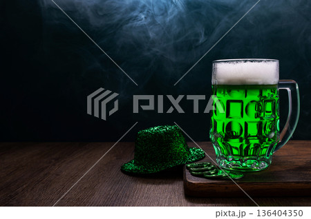 Green beer, hat and clover leaves on grey wooden table. St. Patrick Day celebration 136404350