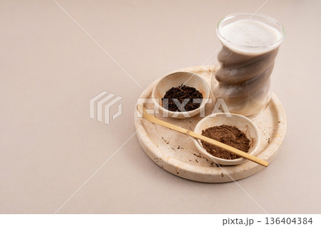 Hojicha Latte with Roasted Green Tea and Powder on Beige Background 136404384