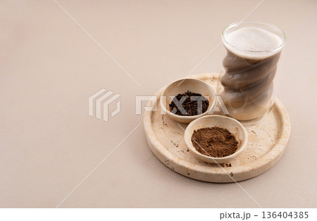 Hojicha Latte with Roasted Green Tea and Powder on Beige Background 136404385