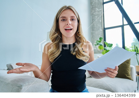 Webcam view young positive woman with business papers having video Webcam view young positive woman with business papers having video 136404399