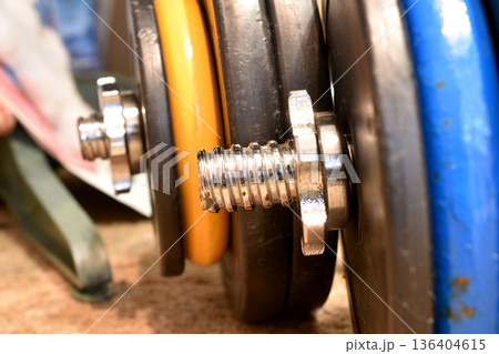 A collapsible dumbbell, a piece of sports equipment for strength training. 136404615