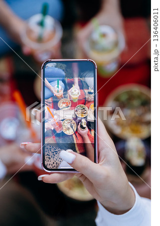Smartphone capturing picnic takeaway bowls and drinks for social media 136406011