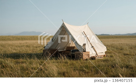 Tent Set up in a Field With Crates and Tools in the Afternoon Sun With Mountains in the Background 136407155