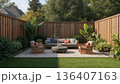 Outdoor Seating Area With Plants and Wooden Fence in a Backyard Setting 136407163