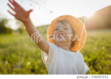 Cute girl playing on meadow, in nauture. Cute girl playing on meadow, in nauture. 136407231