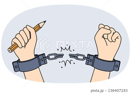 Hands of handcuffed reporter at moment of liberation, holding pencil to write honest investigative journalism. Liberation of man from shackles, as metaphor for emergence of free mass media 136407283