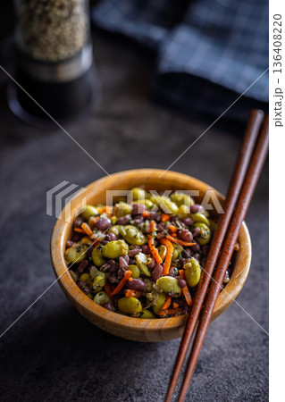 Fresh salad with edamame beans in bowl on black table. 136408220