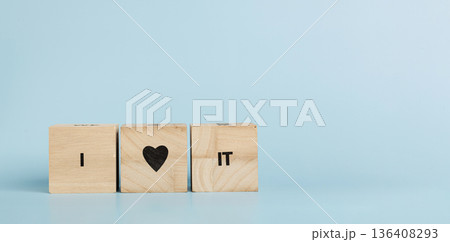 Wooden cubes with inscriptions I Love It on a blue background 136408293
