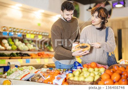Married couple choose papaya together at grocery supermarket 136408746
