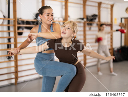Women training self-defense technicians 136408767