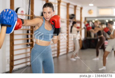Young women in gym boxing training 136408778
