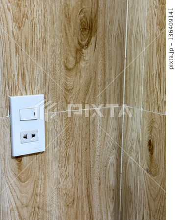 Electrical wall outlet on wooden tile wall Electrical wall outlet on wooden tile wall 136409141