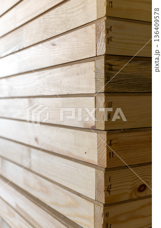 Stack of light wooden board with dovetail joint in carpentry workshop 136409578