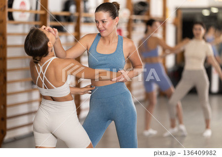Young women in self-defense training Young women in self-defense training 136409982