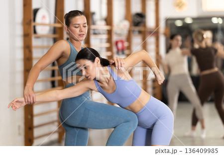 Purposeful engrossed women train during self-defense fight training session in gym 136409985