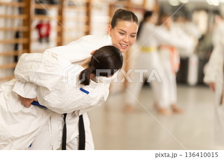 Women in kimono exercising in pairs during training Women in kimono exercising in pairs during training 136410015