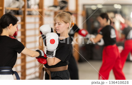 Young women in sportswear boxing 136410028