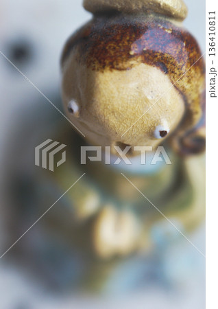 clay figurine in the shape of an angel praying 136410811