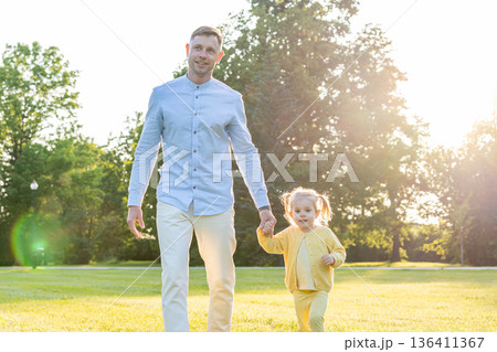Park playtime. Father and toddler enjoying summer nature. Park playtime. Father and toddler enjoying summer nature. 136411367