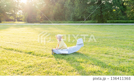Flying girl. Yellow cardboard costume child. Park activity sunshine toddler. 136411368