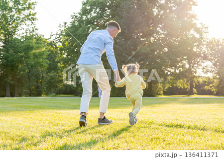 Dad daughter. Dad running with little daughter at sunset. Dad daughter. Dad running with little daughter at sunset. 136411371