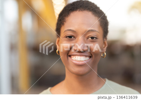 Smiling young Black woman with short hair against 136411639